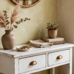 Cozy entryway corner with painted thrifted console table, mirror and shoe basket