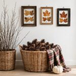 Thanksgiving entryway with foraged branches, pinecone basket, pressed-leaf frames, and a white pumpkin