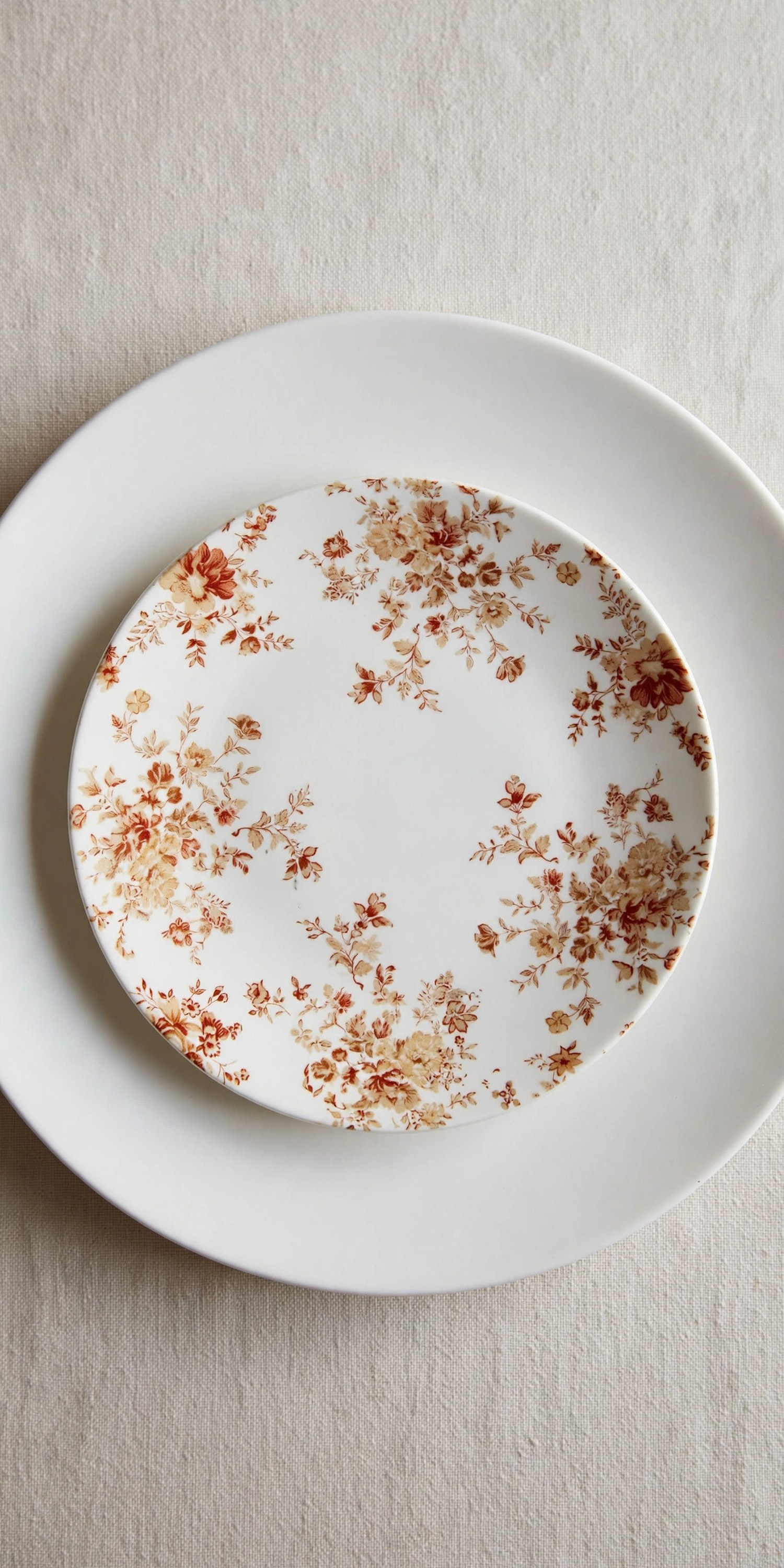 Layered place setting with patterned salad plate on dinner plate